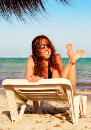 young beautiful smiling woman on a tropical beachの写真素材