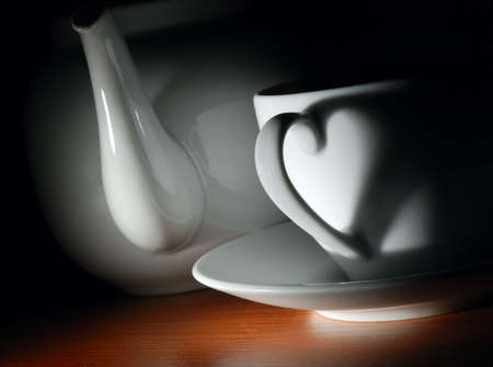 tea cup and teapot in darkの写真素材