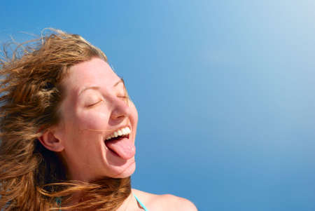 funny woman shows her tongueの写真素材