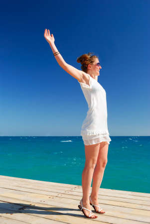 beautiful woman is enjoying the sea freedomの写真素材