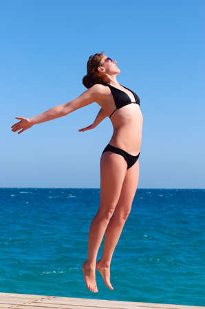 weightless beautiful woman near the seaの写真素材