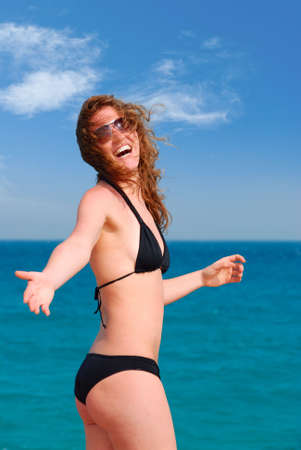 beautiful woman is inviting you to the seaの写真素材