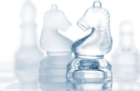 transparent glass chess pieces isolated on white の写真素材