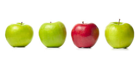 three green apples and one red isolated on whiteの写真素材