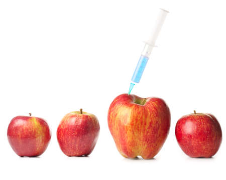 small apples and a big one with syringeの写真素材