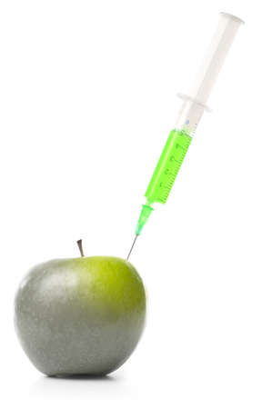 syringe in green apple isolated on whiteの写真素材