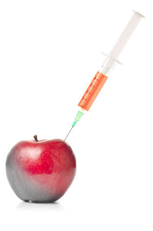syringe in red apple isolated on whiteの写真素材