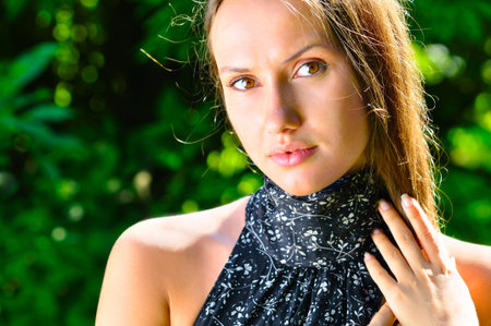 sexy young woman in trees at sunny weatherの写真素材