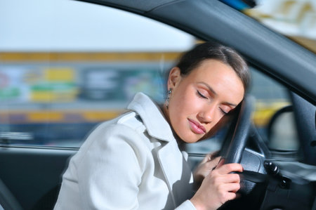 beautiful woman is sleeping in a car