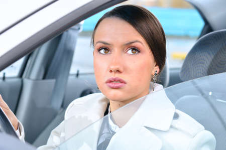 woman in a car is looking upwardsの写真素材