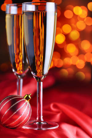 two champagne glasses on red silkの写真素材