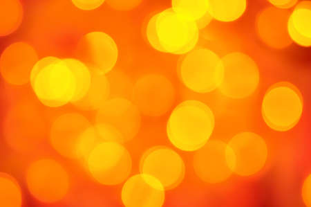 blurred golden lights on red backgroundの写真素材
