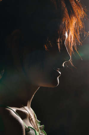 silhouette at night of  a young ginger woman の写真素材