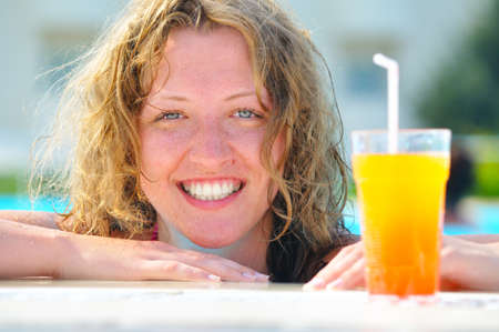 close up of pretty woman in swimming pool with cocktail の写真素材