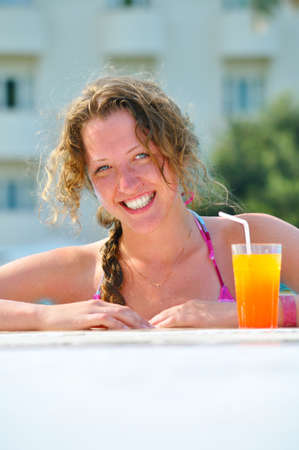 attractive woman is smiling from swimming pool in resort の写真素材