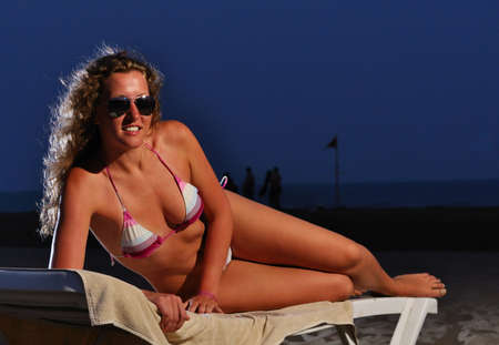 happy woman is lying on the night beachの写真素材