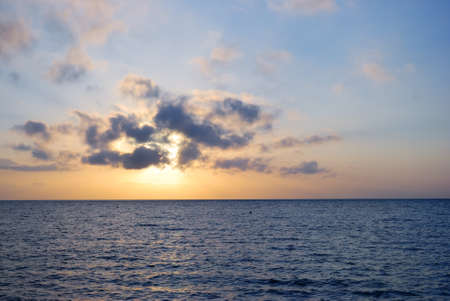 blue fantastic ocean sunrise at cloudy weatherの写真素材
