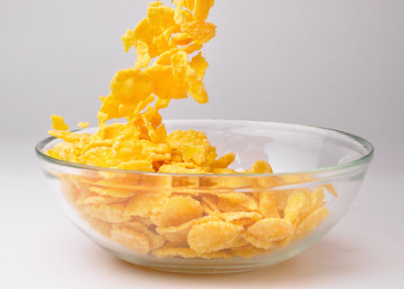 closeup of a bowl with pouring cereal flakes