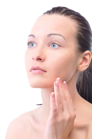 beautiful woman is touching her face, isolated on whiteの写真素材