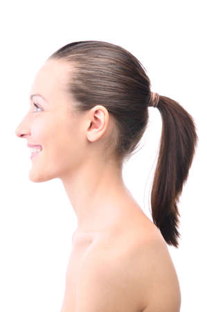happy smiling beautiful young woman is looking sideways isolated on whiteの写真素材