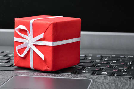 red gift box on a laptop keyboardの写真素材
