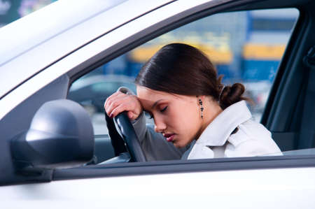 beautiful woman is sleeping in a car の写真素材