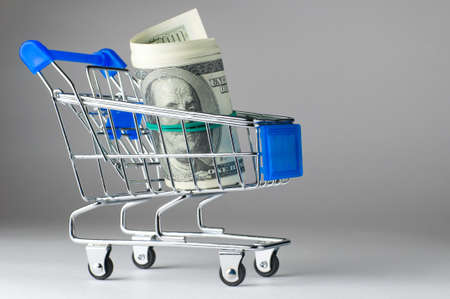 dollar notes in shopping cartの写真素材