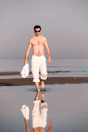 man is walking at sea coastの写真素材