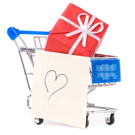 closeup of a shopping cart with gifts and heartの写真素材