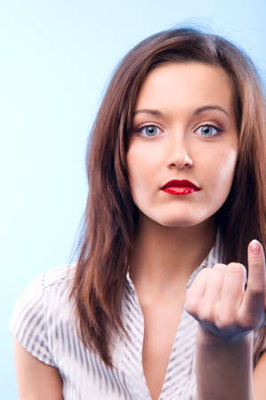 sexy long haired business woman with deep red lips is looking at camera and beckoning の写真素材