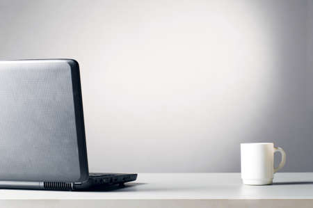laptop with white cupの写真素材