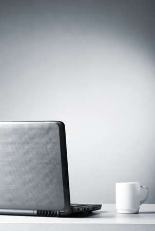 laptop with white cupの写真素材