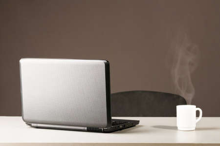 laptop with white cupの写真素材