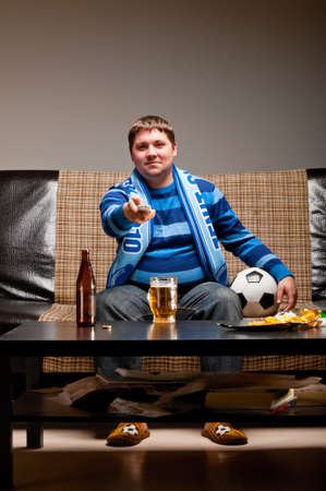 soccer fan on sofaの写真素材