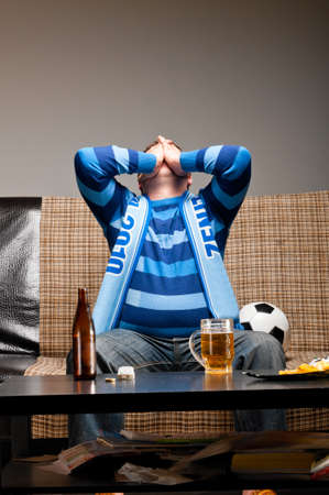 soccer fan on sofaの写真素材