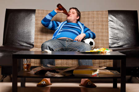 soccer fan on sofaの写真素材