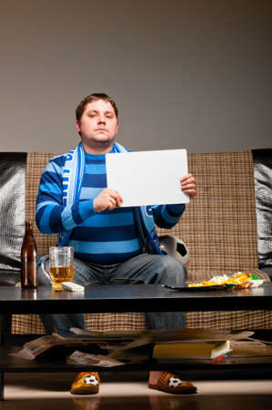 soccer fan on sofaの写真素材