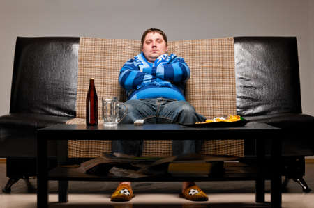 soccer fan on sofaの写真素材