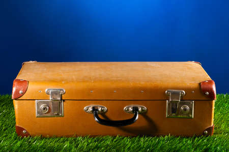 old suitcase on grass, concept of travellingの写真素材