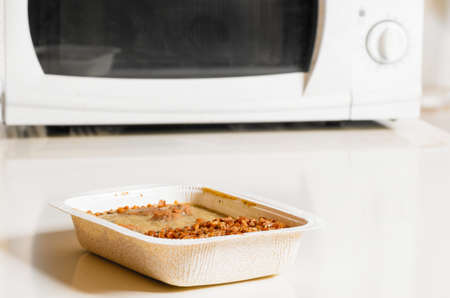 microwave oven with frozen foodの写真素材