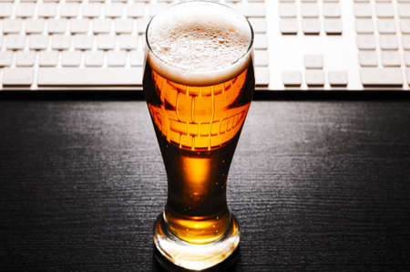 glass of lager beer on tableの写真素材