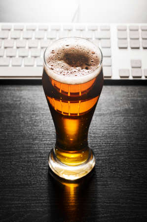 glass of lager beer on tableの写真素材