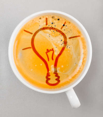 idea  cup of fresh espresso with bulb sign, view from aboveの写真素材