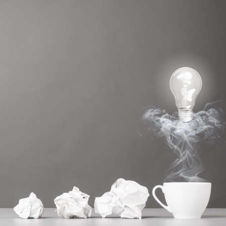 creative process  crumpled wads and cup on grayの写真素材