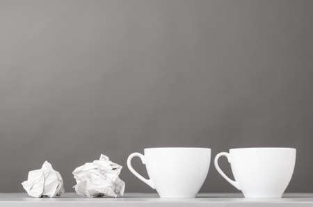 creative process  crumpled wads and cup on grayの写真素材