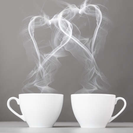 love and coffee  heart silhouettes from steaming hot coffee cupsの写真素材