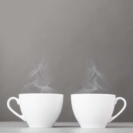 cups of hot coffee on gray backgroundの写真素材