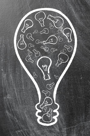 synergy  huge bulb made of small ones on chalk boardの写真素材