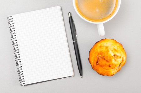 creative process  blank notebook and cup on gray