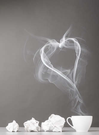love letter  crumpled wads and heart silhouette on grayの写真素材